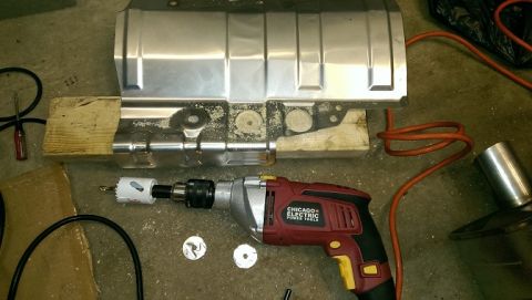 2015 Subaru Forester - A metal component is being worked on with a drill and hole saw.