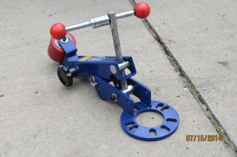1985 Volkswagen Jetta - A blue automotive tool, possibly for wheel alignment, is shown on a concrete surface.