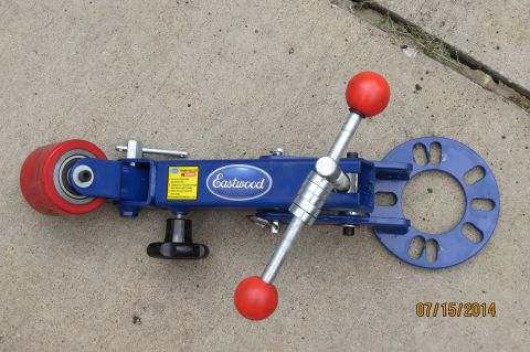 1985 Volkswagen Jetta - A blue Eastwood fender roller tool, designed for automotive body work, is shown resting on a concrete surface.
