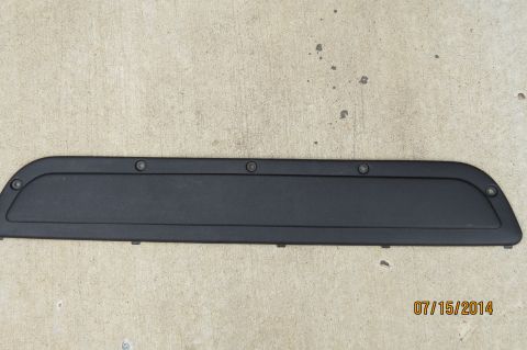 1985 Volkswagen Jetta - A black plastic trim piece is shown against a concrete background, with a date stamp and website URL in the lower right corner.