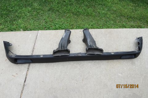 1985 Volkswagen Jetta - A black front bumper assembly with two air ducts is displayed outdoors on a concrete surface.