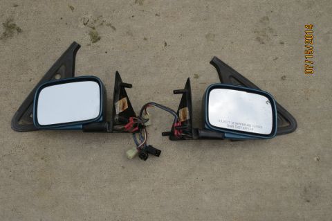 1985 Volkswagen Jetta - Pair of side mirrors with wiring, possibly for a car. One mirror has warning text.