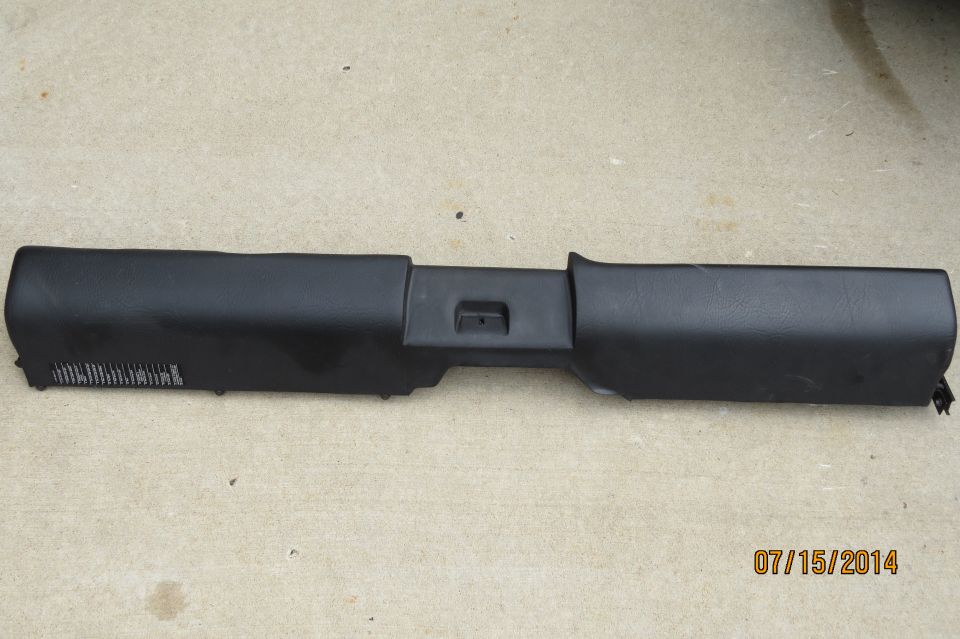 Black plastic trim piece with some text on the left side