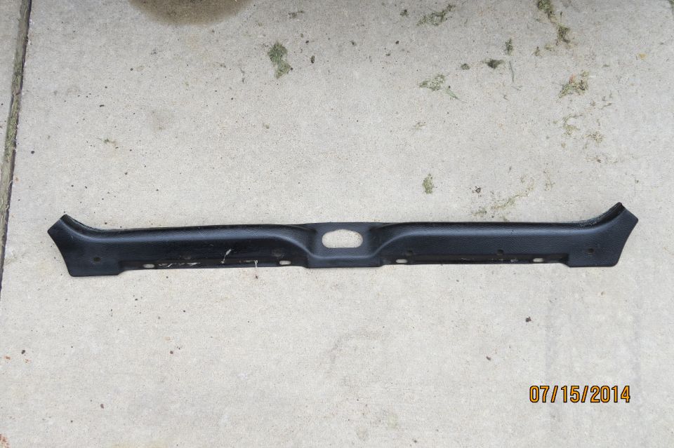 Black plastic trim piece with oval cutout