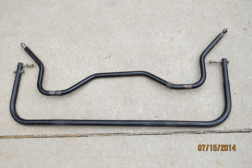 Two black sway bars on concrete, one U-shaped and one curved