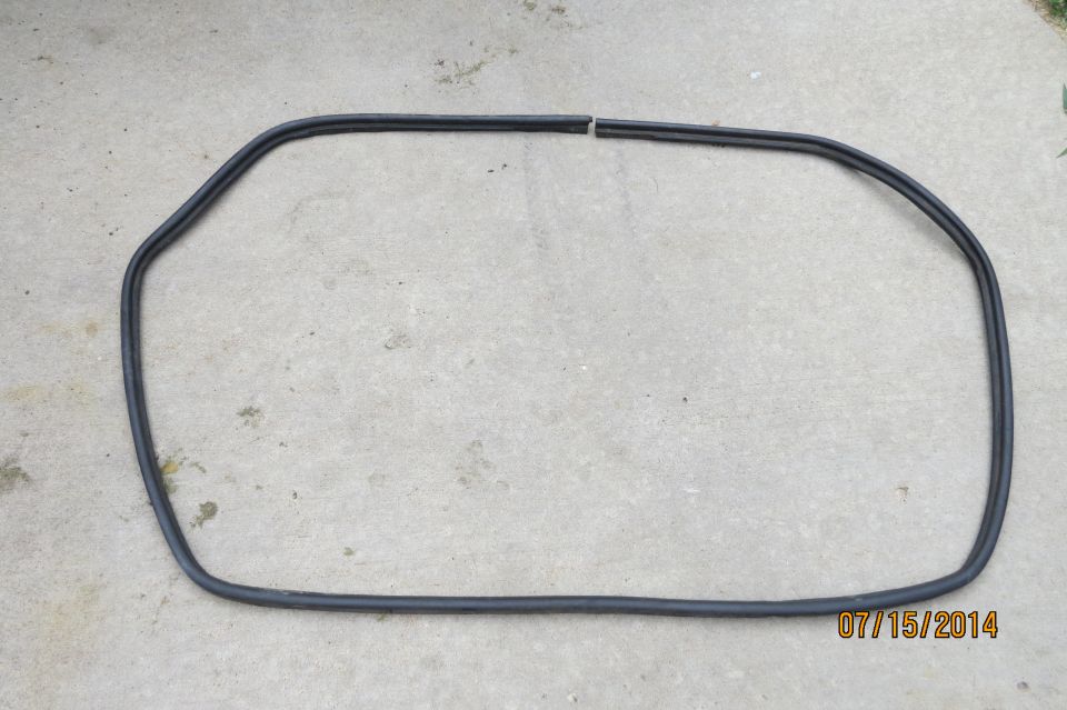 Black rubber seal on concrete surface, broken in one section
