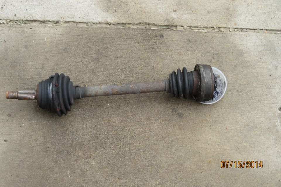 CV axle with rubber boots on concrete, dated 07/15/2014
