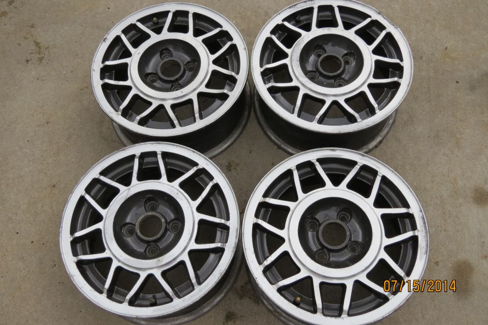 Four alloy wheels with a silver and black multi-spoke design