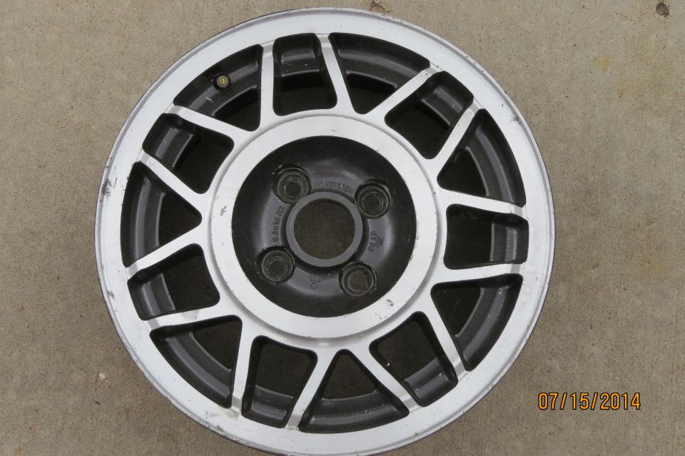 Volkswagen alloy wheel with 4 lug nuts visible