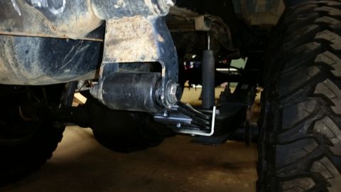 1988 Ford Bronco - The rear suspension system and a large off-road tire are visible in this close-up shot.