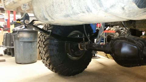 1988 Ford Bronco - Close-up view of the rear axle and suspension system of a vehicle.