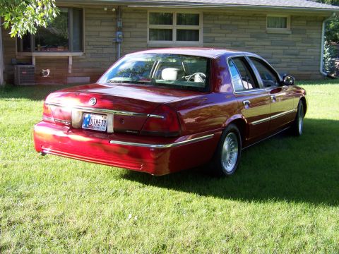 1999 Mercury Grand Marquis - This 1999 Mercury Grand Marquis is seen from the rear, parked on a grassy lawn in front of a house.