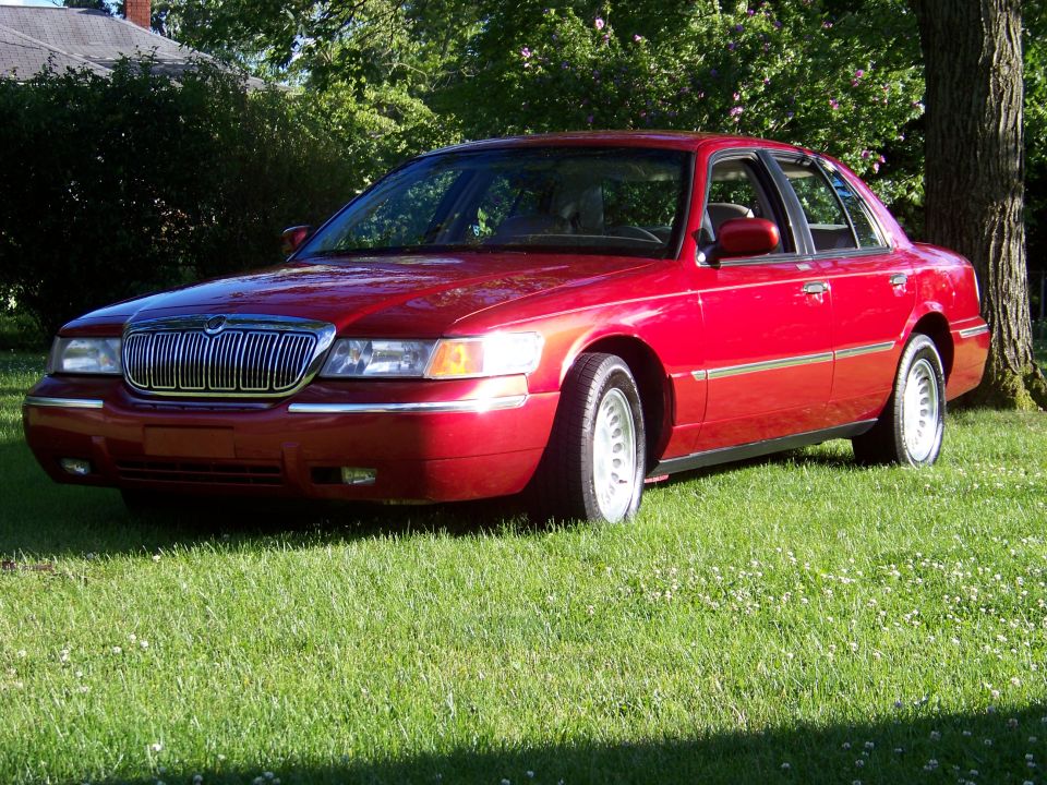 1999 Mercury Grand Marquis parked on grass, front 3/4 view