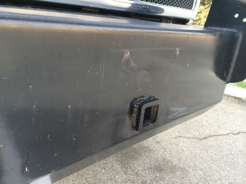1997 Dodge 3500 - Close-up of a black bumper a trailer hitch receiver.