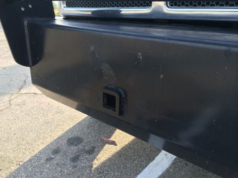 1997 Dodge 3500 - Close-up of a heavy-duty truck's front bumper, showing a hitch receiver and part of the grille.
