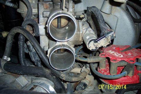 1990 Ford Bronco - Close-up view of engine components including the throttle body and distributor cap.