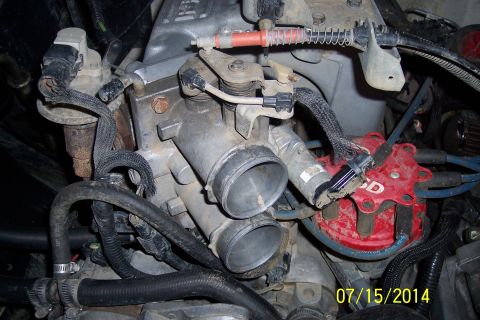 1990 Ford Bronco - Engine components including throttle body and distributor cap are visible in this close-up shot.