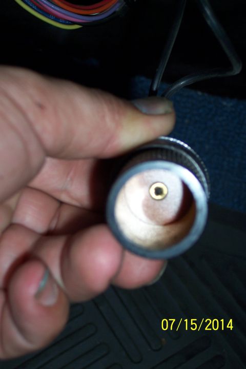 1990 Ford Bronco - Close-up of a hand holding a car's cigarette lighter socket.