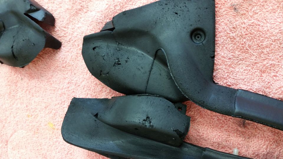 Black plastic car parts on pink towel