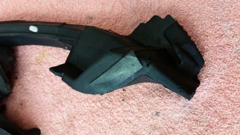 1973 Chevrolet Camaro - Close-up of a black rubber seal part, likely for a vehicle, resting on a pink textured surface.