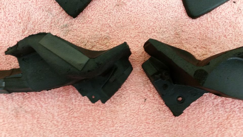 Black rubber car parts on pink fabric