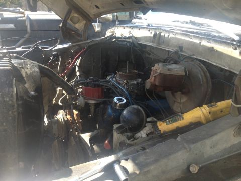 1979 Ford Bronco - Engine bay details with tools present, no specific year identified.