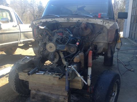 Truck body on blocks, engine out, another truck next to it