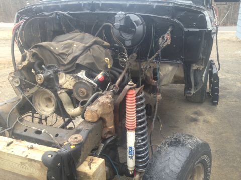 1979 Ford Bronco engine bay with engine removed, showing suspension and frame