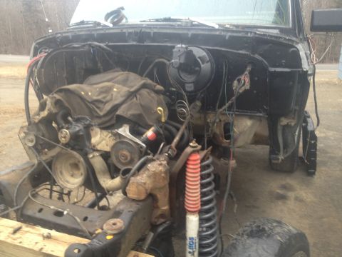 1979 Ford Bronco engine bay with engine removed, showing suspension and frame