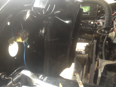 Black engine bay components with visible wiring and a green label