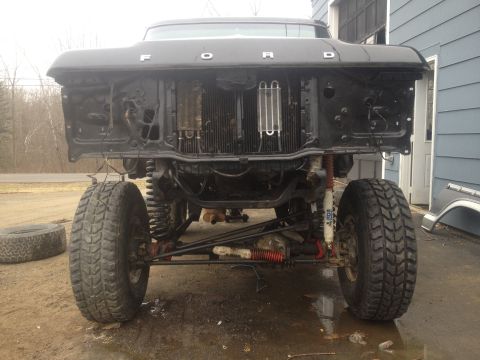 1979 Ford Bronco front end with grille removed, showing radiator and suspension components
