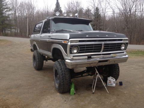 Two-tone lifted 1979 Ford Bronco with roof lights and aftermarket grille