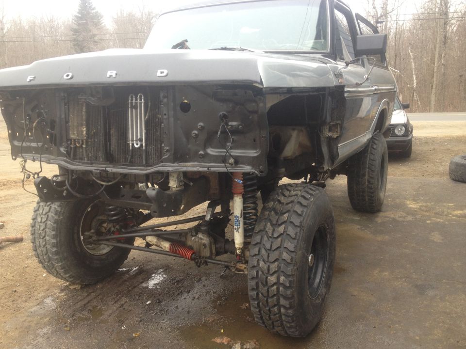 1979 Ford Bronco front end with grille removed, showing engine bay and suspension components