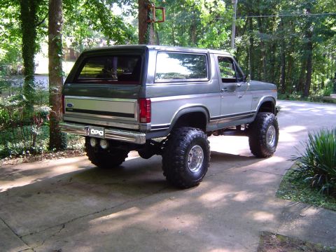 1986 Ford Bronco - Rear view of a lifted 1986 Ford Bronco with custom wheels and tires.