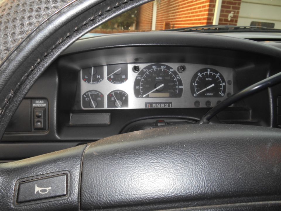 1994 Ford Bronco interior dashboard with gauges and steering wheel. Shows 'R RN@21' on gear indicator