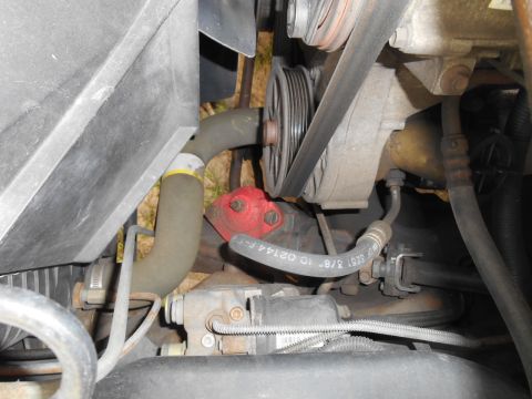 1994 Ford Bronco - A view of the engine bay, focusing on hoses and the serpentine belt system.