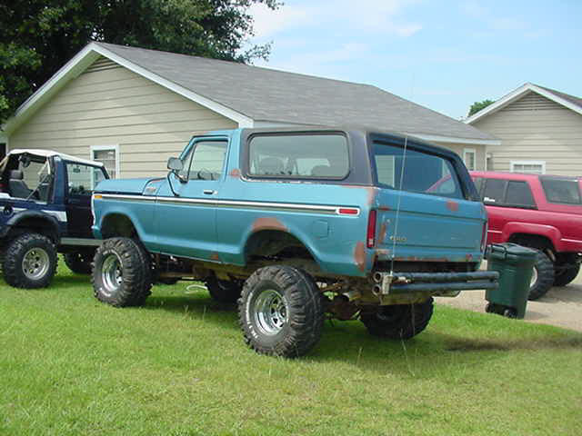 Blue 1979 Ford Bronco, 3/4 front view, lifted with large tires