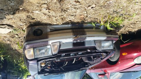 1991 Ford LTD Crown Victoria - The front of a damaged car is shown, with another vehicle partially visible beside it.