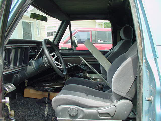 Interior of a 1979 Ford Bronco, showing the driver's seat, steering wheel, and dashboard
