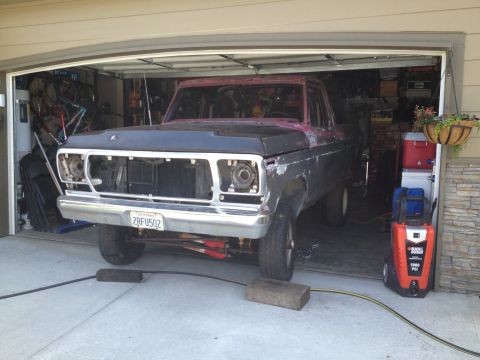 1978 Ford Bronco - This truck is undergoing restoration in a garage, with its front end disassembled.