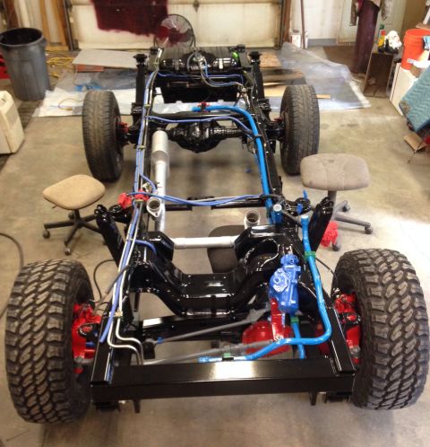 1993 Ford Bronco - The chassis and drivetrain of a 1993 Ford Bronco are shown during a restoration or build process.