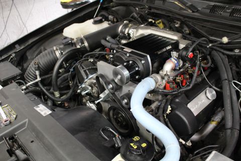 2003 Ford Crown Victoria - Engine compartment with a Kenne Bell supercharger, serpentine belt drive, and blue silicone coolant tubing.