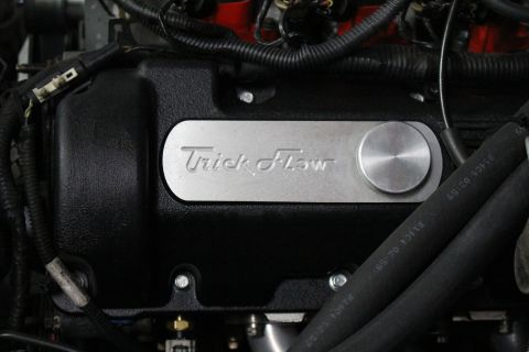 2003 Ford Crown Victoria - Close-up of a textured black Trick Flow valve cover with a brushed aluminum oil filler cap and braided lines.
