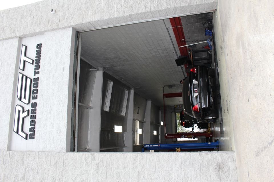 Racers Edge Tuning shop doorway with black sedan inside