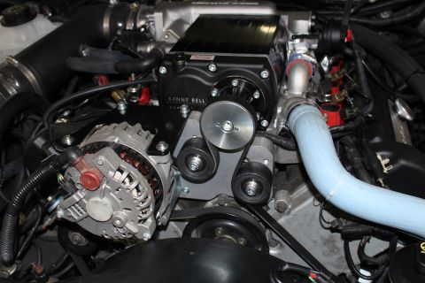2003 Ford Crown Victoria - Close-up of a Kenne Bell supercharger drive with alternator, idler pulleys and blue silicone coolant hose.