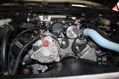 2003 Ford Crown Victoria - Close-up of a Kenne Bell supercharger pulley system with chrome alternator and blue silicone coolant hose.