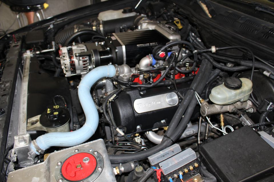 Engine bay with Kenne Bell blower, Trick Flow cover and red fuel plate