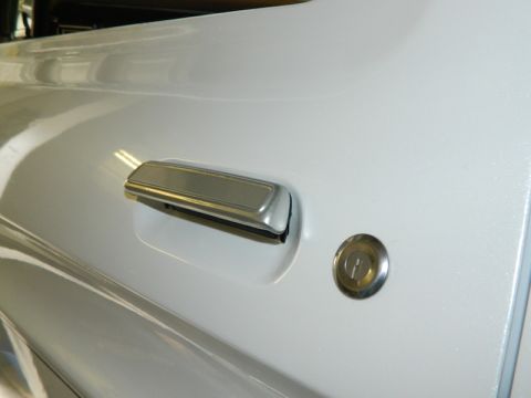 1979 Ford Bronco - Close-up of a vehicle's door handle and lock cylinder.