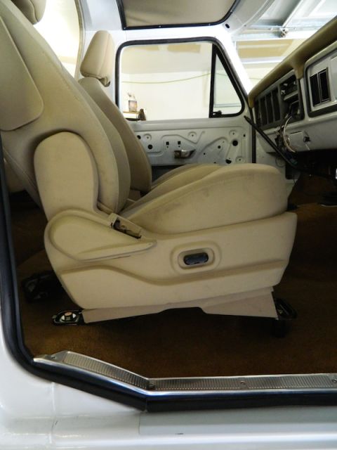1979 Ford Bronco - Interior view of a 1979 Ford Bronco, showing tan bucket seats and door panel.