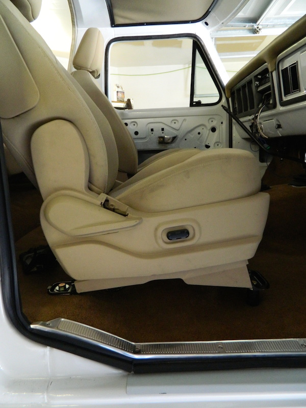 Tan bucket seats and door panel in a 1979 Ford Bronco interior